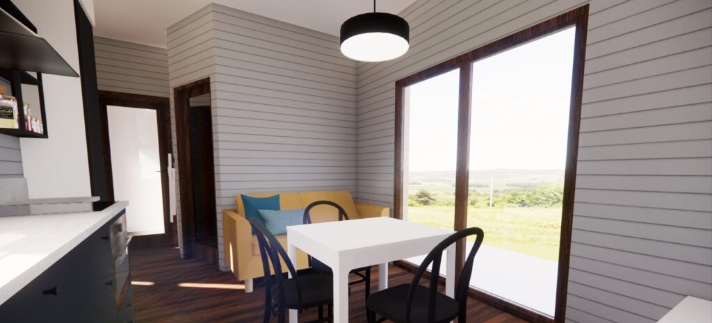 Nowoczesny domek modułowy z jasnym wnętrzem, wyposażony w stół i krzesła, oraz wygodną sofę. Duże okna zapewniają naturalne światło i widok na okolicę, idealny dla osób szukających domków mobilnych lub domów modułowych na wypoczynek.