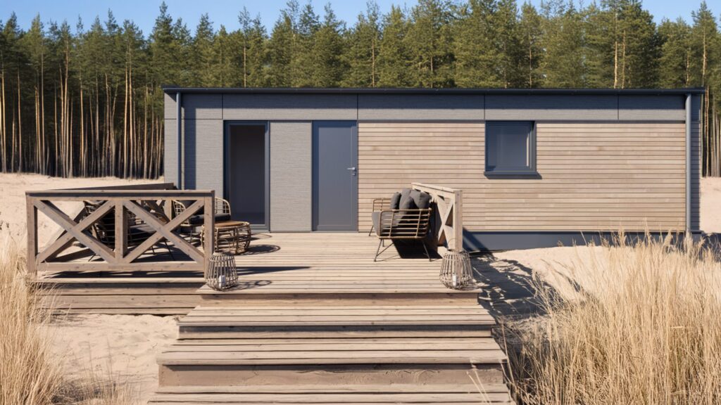 Domek modułowy z tarasem, idealny jako domek mobilny lub dom mobilny, otoczony zielenią. Nowoczesny design i funkcjonalność sprawiają, że to doskonały wybór dla osób szukających domów modułowych.